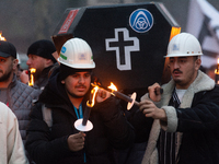 A hundred Thyssenkrupp Europe Steel workers march with a coffin against planned job cuts before heading to the Works Council meeting in Duis...