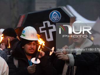 A hundred Thyssenkrupp Europe Steel workers march with a coffin against planned job cuts before heading to the Works Council meeting in Duis...