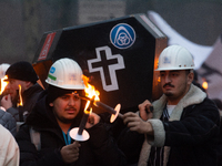 A hundred Thyssenkrupp Europe Steel workers march with a coffin against planned job cuts before heading to the Works Council meeting in Duis...