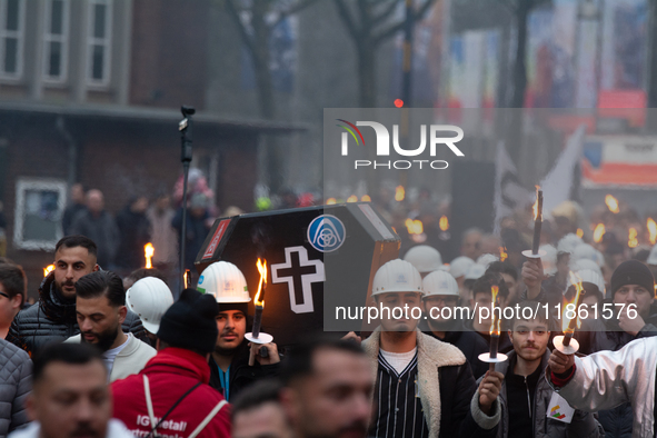 A hundred Thyssenkrupp Europe Steel workers march with a coffin against planned job cuts before heading to the Works Council meeting in Duis...