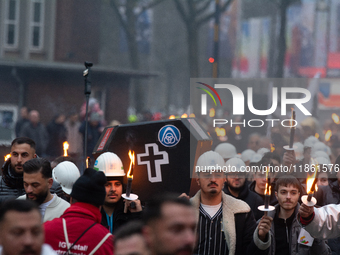 A hundred Thyssenkrupp Europe Steel workers march with a coffin against planned job cuts before heading to the Works Council meeting in Duis...