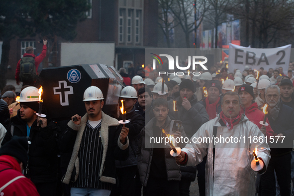 A hundred Thyssenkrupp Europe Steel workers march with a coffin against planned job cuts before heading to the Works Council meeting in Duis...