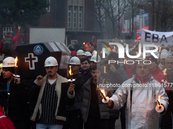 A hundred Thyssenkrupp Europe Steel workers march with a coffin against planned job cuts before heading to the Works Council meeting in Duis...