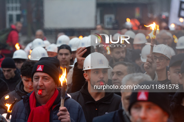 A hundred Thyssenkrupp Europe Steel workers march with a coffin against planned job cuts before heading to the Works Council meeting in Duis...