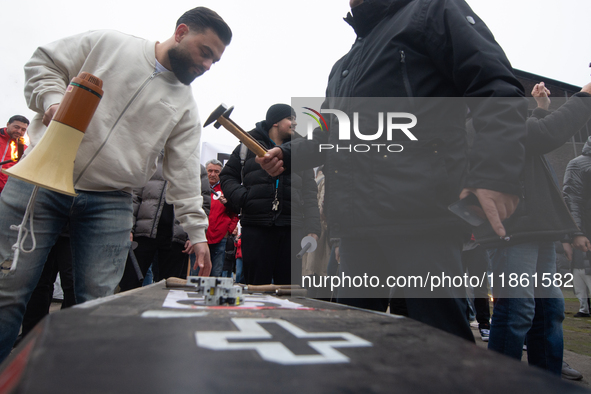 A hundred Thyssenkrupp Europe Steel workers march with a coffin against planned job cuts before heading to the Works Council meeting in Duis...