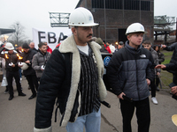 A hundred Thyssenkrupp Europe Steel workers march with a coffin against planned job cuts before heading to the Works Council meeting in Duis...