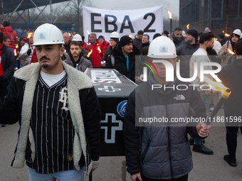 A hundred Thyssenkrupp Europe Steel workers march with a coffin against planned job cuts before heading to the Works Council meeting in Duis...