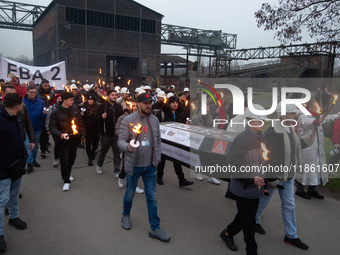 A hundred Thyssenkrupp Europe Steel workers march with a coffin against planned job cuts before heading to the Works Council meeting in Duis...