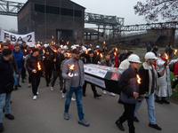 A hundred Thyssenkrupp Europe Steel workers march with a coffin against planned job cuts before heading to the Works Council meeting in Duis...