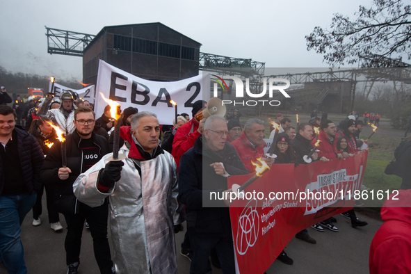 A hundred Thyssenkrupp Europe Steel workers march with a coffin against planned job cuts before heading to the Works Council meeting in Duis...