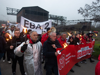 A hundred Thyssenkrupp Europe Steel workers march with a coffin against planned job cuts before heading to the Works Council meeting in Duis...