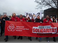 A hundred Thyssenkrupp Europe Steel workers march with a coffin against planned job cuts before heading to the Works Council meeting in Duis...