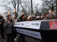 A hundred Thyssenkrupp Europe Steel workers march with a coffin against planned job cuts before heading to the Works Council meeting in Duis...