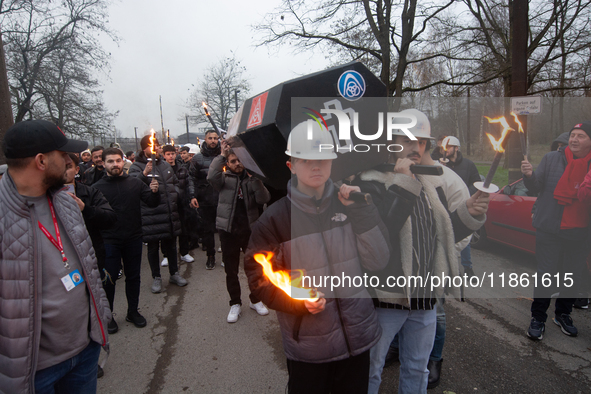 A hundred Thyssenkrupp Europe Steel workers march with a coffin against planned job cuts before heading to the Works Council meeting in Duis...