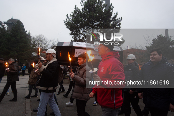 A hundred Thyssenkrupp Europe Steel workers march with a coffin against planned job cuts before heading to the Works Council meeting in Duis...