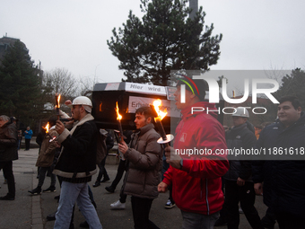 A hundred Thyssenkrupp Europe Steel workers march with a coffin against planned job cuts before heading to the Works Council meeting in Duis...