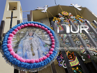 An image of the Virgin of Guadalupe is displayed in Santa Maria Tomatlan in the Iztapalapa municipality, Mexico City, on December 12, 2024,...