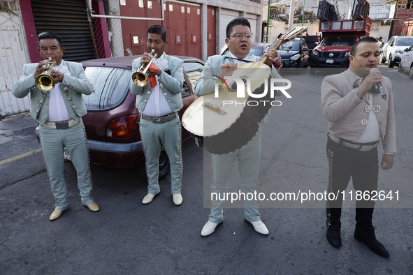 Mariachis sing to the Virgin of Guadalupe in Santa Maria Tomatlan in the Iztapalapa borough, Mexico City, on December 12, 2024, during the c...