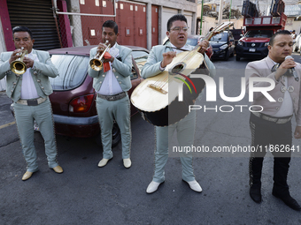 Mariachis sing to the Virgin of Guadalupe in Santa Maria Tomatlan in the Iztapalapa borough, Mexico City, on December 12, 2024, during the c...