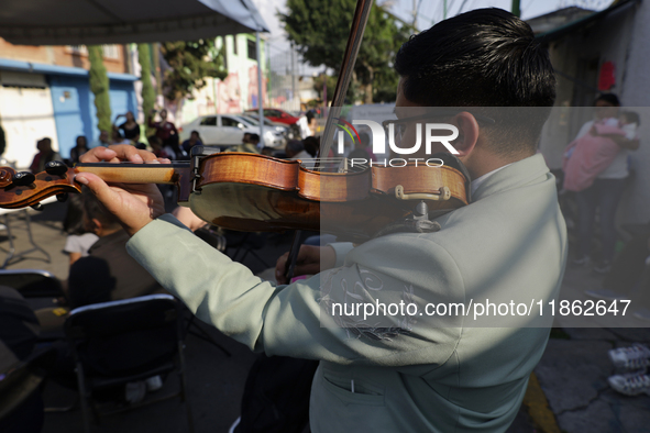 A mariachi sings to the Virgin of Guadalupe in Santa Maria Tomatlan in the Iztapalapa borough, Mexico City, on December 12, 2024, during the...