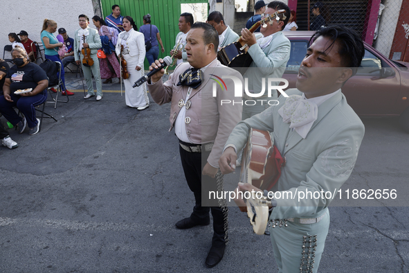 Mariachis sing to the Virgin of Guadalupe in Santa Maria Tomatlan in the Iztapalapa borough, Mexico City, on December 12, 2024, during the c...