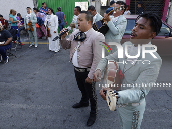 Mariachis sing to the Virgin of Guadalupe in Santa Maria Tomatlan in the Iztapalapa borough, Mexico City, on December 12, 2024, during the c...