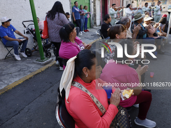 Residents of Santa Maria Tomatlan in the Iztapalapa municipality, Mexico City, live together during the celebration of the Day of the Virgin...