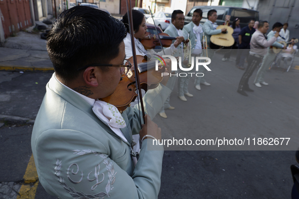 Mariachis sing to the Virgin of Guadalupe in Santa Maria Tomatlan in the Iztapalapa borough, Mexico City, on December 12, 2024, during the c...