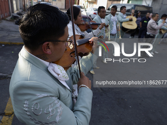 Mariachis sing to the Virgin of Guadalupe in Santa Maria Tomatlan in the Iztapalapa borough, Mexico City, on December 12, 2024, during the c...