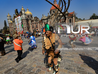 A dancer participates in the pre-Hispanic dance during the celebrations of the Day of the Virgin of Guadalupe in Mexico City, Mexico, on Dec...