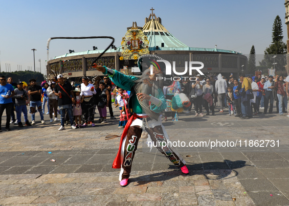 A person dressed in a regional costume takes part in a dance during the celebrations of the Day of the Virgin of Guadalupe in Mexico City, M...