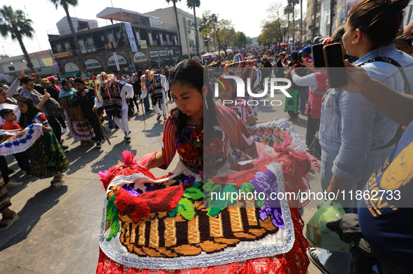 A woman dressed in a folkloric dress takes part in a dance during the celebrations of the Day of the Virgin of Guadalupe in Mexico City, Mex...