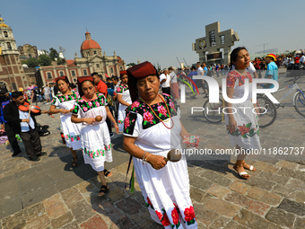 Dancers participate in the pre-Hispanic dance during the celebrations of the Day of the Virgin of Guadalupe in Mexico City, Mexico, on Decem...