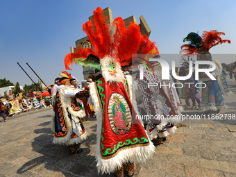 Dancers participate in the pre-Hispanic dance during the celebrations of the Day of the Virgin of Guadalupe in Mexico City, Mexico, on Decem...