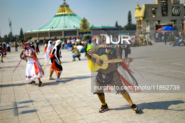 A person dressed in a folk costume takes part in a dance during the celebrations of the Day of the Virgin of Guadalupe in Mexico City, Mexic...