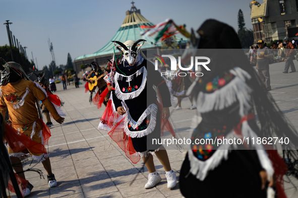 A person dressed in a folk costume takes part in a dance during the celebrations of the Day of the Virgin of Guadalupe in Mexico City, Mexic...