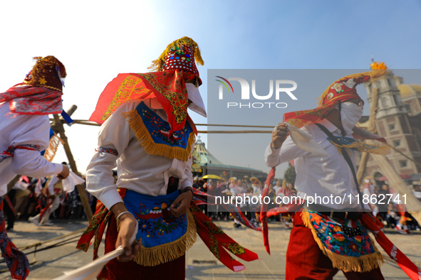 People dressed in folk costumes take part in a dance during the celebrations of the Day of the Virgin of Guadalupe in Mexico City, Mexico, o...