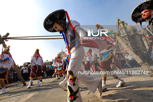 People dressed in folk costumes take part in a dance during the celebrations of the Day of the Virgin of Guadalupe in Mexico City, Mexico, o...