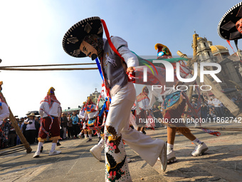 People dressed in folk costumes take part in a dance during the celebrations of the Day of the Virgin of Guadalupe in Mexico City, Mexico, o...