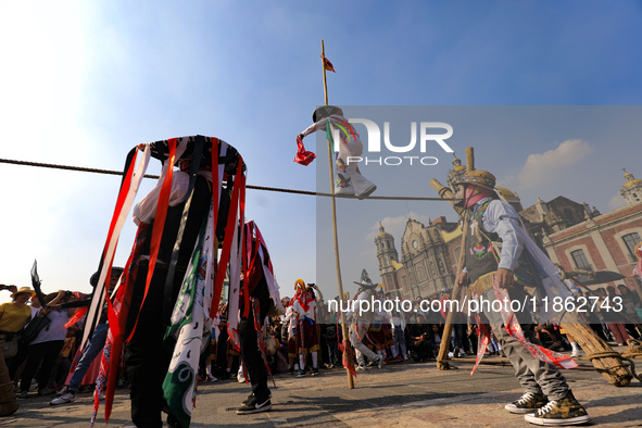 People dressed in folk costumes take part in a dance during the celebrations of the Day of the Virgin of Guadalupe in Mexico City, Mexico, o...