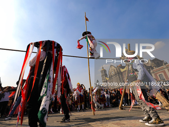 People dressed in folk costumes take part in a dance during the celebrations of the Day of the Virgin of Guadalupe in Mexico City, Mexico, o...