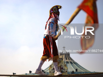 A person dressed in a folk costume takes part in a dance during the celebrations of the Day of the Virgin of Guadalupe in Mexico City, Mexic...