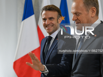 WARSAW, POLAND - DECEMBER 12:
Polish PM Donald Tusk (R) welcomes French President Emmanuel Macron at the PM's Office in Warsaw, Poland, on D...