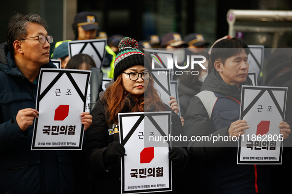 Around 30 members of the Korean Confederation of Trade Unions (KCTU) and other civil society groups hold a press conference in front of the...