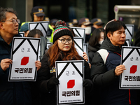 Around 30 members of the Korean Confederation of Trade Unions (KCTU) and other civil society groups hold a press conference in front of the...