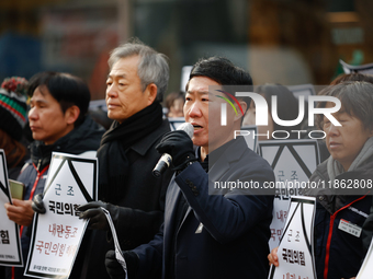 Around 30 members of the Korean Confederation of Trade Unions (KCTU) and other civil society groups hold a press conference in front of the...