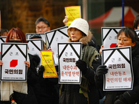 Around 30 members of the Korean Confederation of Trade Unions (KCTU) and other civil society groups hold a press conference in front of the...