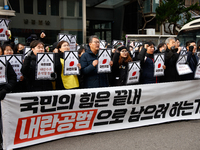 Around 30 members of the Korean Confederation of Trade Unions (KCTU) and other civil society groups hold a press conference in front of the...