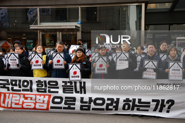 Around 30 members of the Korean Confederation of Trade Unions (KCTU) and other civil society groups hold a press conference in front of the...