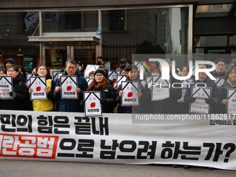 Around 30 members of the Korean Confederation of Trade Unions (KCTU) and other civil society groups hold a press conference in front of the...